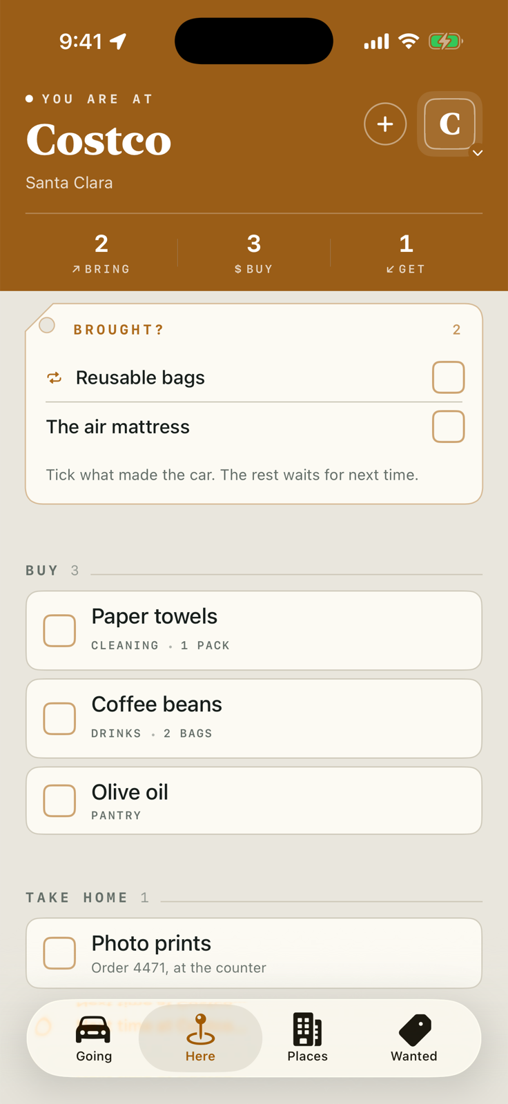 The Here screen after arriving at Costco: a marigold band reading You are at Costco, Santa Clara, counts of 2 bring, 3 buy, 1 get, a punched Brought? tag listing reusable bags and the air mattress, then the Buy list.